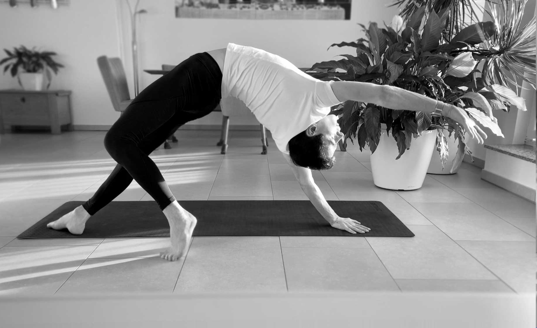 Background image showing a person in a yoga pose, representing how humans, unfortunately still need to bent and adapt to the technical environment, rather than technology adapts to human needs.